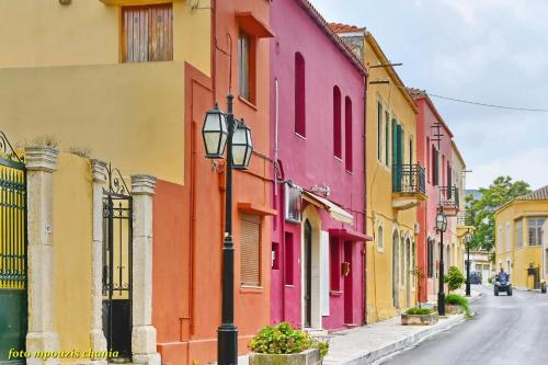 a street with brightly colored buildings in a city at Kalomiris Thea Suite in Archanes