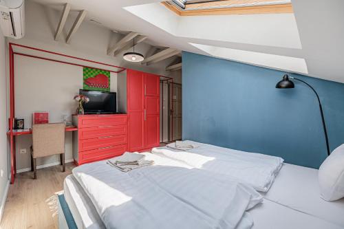 a bedroom with red and blue walls and a bed at Bohém Borklub in Tállya