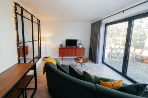a living room with a couch and a tv at The Observatory Annexe in Dorking