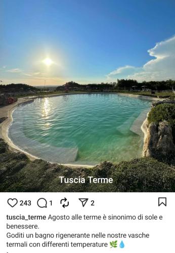a pool of water with the sun in the background at Villa Celestina, a 10 minuti dalle Terme in Vetralla