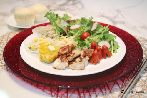 a plate of food with a salad on a table at Piccola casa awaji in Awaji