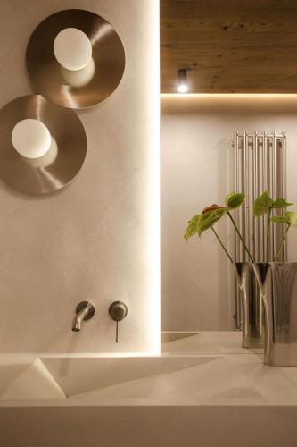 a bathroom with two lights and a sink at Baniska Houses Mountain View DOM Z WIDOKIEM NA TATRY JACUZZI ORAZ SAUNA W CENIE in Szaflary