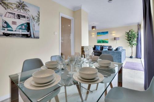 a dining room with a glass table and chairs at Oceanview Retreat & Private Parking in Saltdean