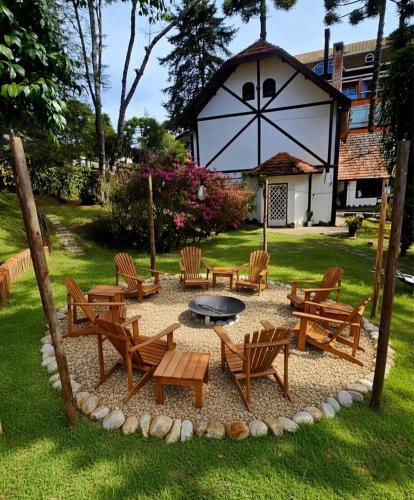 a group of chairs and tables in a yard at Casa do Atleta in Campos do Jordão