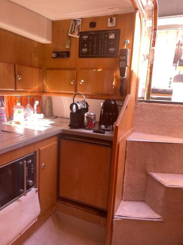 a small kitchen with a stove and a sink at Logement insolite French Riviera avec parking in Antibes