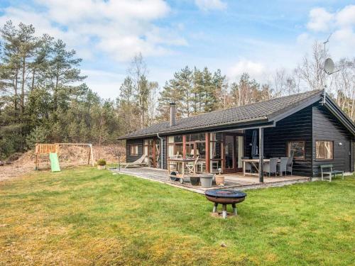 a log cabin with a grill in the yard at 6 person holiday home in Læsø-By Traum in Læsø