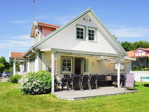 a house with a deck with chairs and a couch at 9 person holiday home in SOLLENTUNA-By Traum in Sollentuna