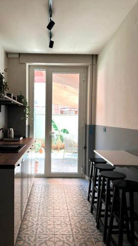 a kitchen with a table and chairs and a sliding glass door at Residenza Duca degli Abruzzi in Pescara