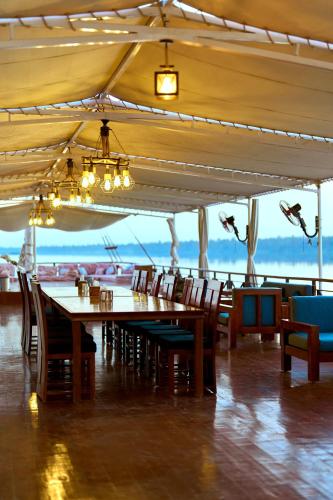 a dining room with a long table and chairs at Fatima Dahabiya in Luxor