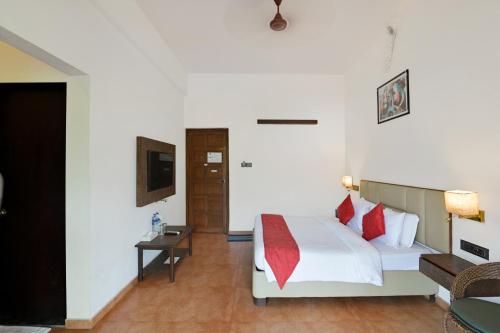 a hotel room with a bed and a television at Vaarsa by Bay Hotels in Alibaug
