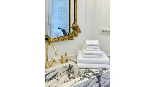 a bathroom with a mirror and white towels on a counter at LEtoile du Lac in Blevio