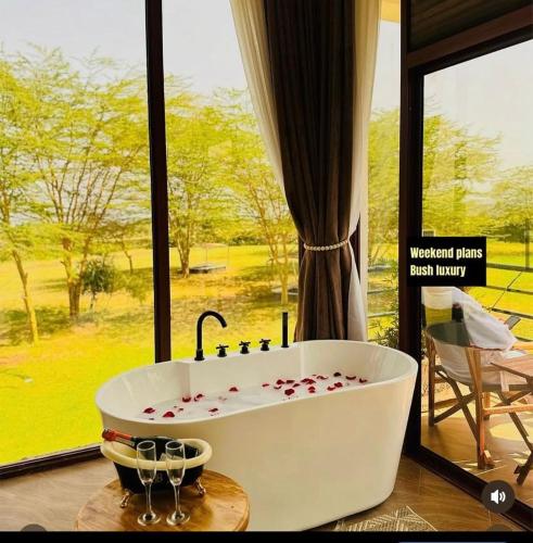 a bath tub with hearts on it in front of a window at Lake Elementaita Manor in Gilgil