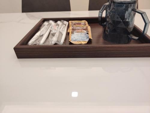 a wooden tray with toothbrushes and a blender on a counter at Kuromi Homestay Port Dickson Ground Floor in Port Dickson