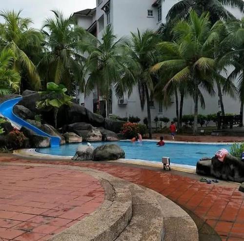 a swimming pool with animals in a resort at Kuromi Homestay Port Dickson Ground Floor in Port Dickson