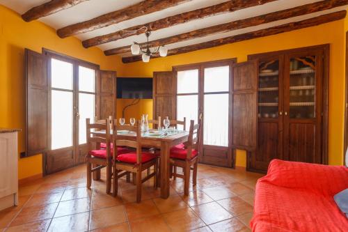 a dining room with a table and chairs at CASA RURAL LES ROQUETES in Ráfales