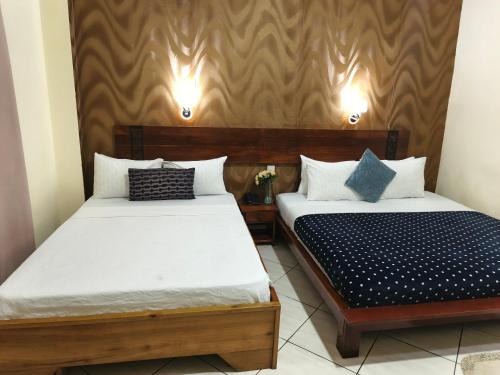 two beds in a small room with at Paloma Hotel Ring Road in Accra
