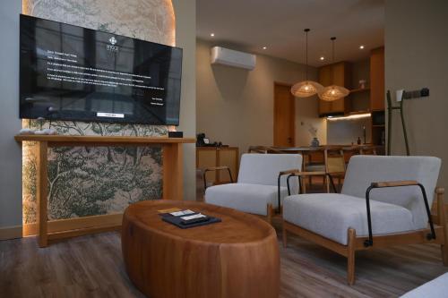 a living room with a large flat screen tv at Hygge Hotel and Villas Seminyak in Seminyak