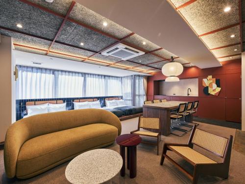 a living room with a couch and a table at illi Jam Shinsaibashi in Osaka