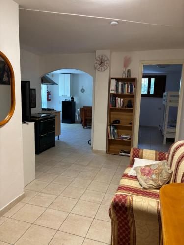 a living room with a couch and a kitchen at Casa privata in collina in Gemmano