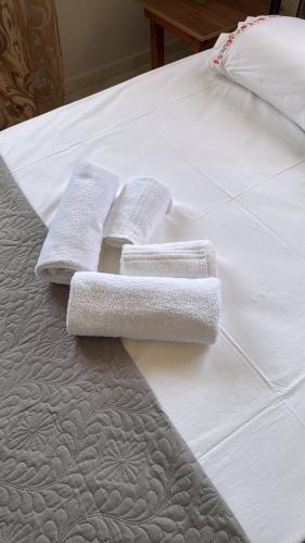 two towels are sitting on a white bed at PANKO Suite in Dhímitra