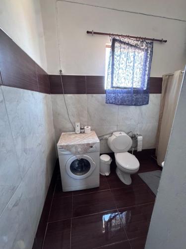 a small bathroom with a toilet and a sink at PANKO Suite in Dhímitra