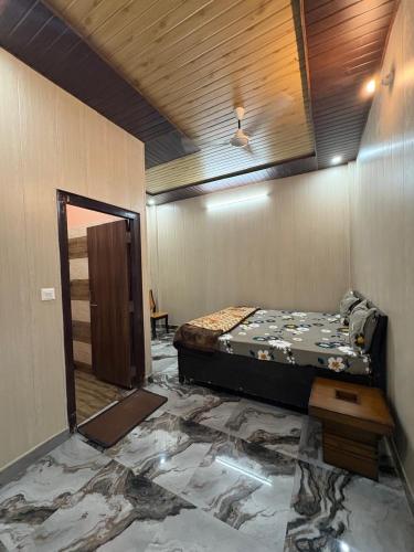 a room with a bed in the middle of a room at Chirag Homestay Kainchi in Nainital