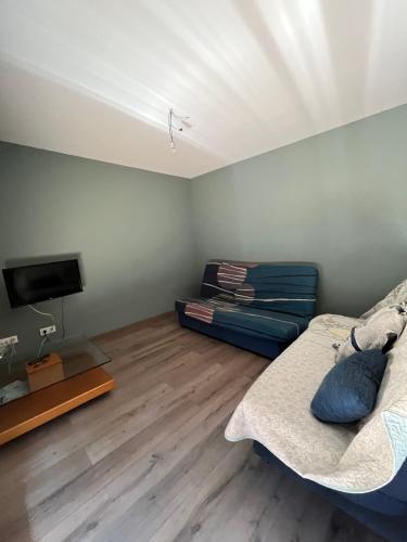 a living room with a couch and a flat screen tv at Villa Buiza in Cunit