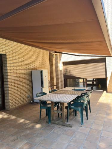 a wooden table and chairs on a patio at Villa Buiza in Cunit