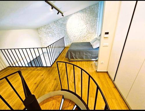 a small room with a bed and a staircase at Ethereal Residences Nafplio 4 in Nafplio