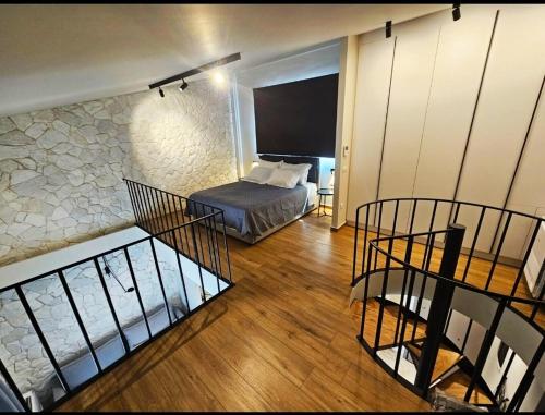 a bedroom with a bed and a staircase in a room at Ethereal Residences Nafplio 4 in Nafplio