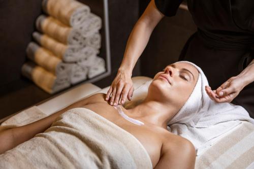 a woman getting a massage at a spa at Hi Hotels Trento - Wellness & Spa Adults Only in Trento