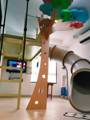 a room with a bunk bed with a telescope at Cyberjaya HOMEstay With Playground Slide - 5 Pax in Gua Sai