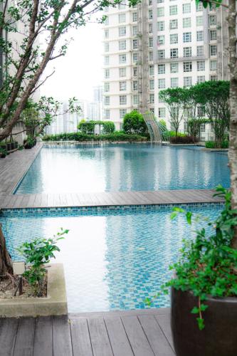 a large swimming pool in a city with tall buildings at Cyberjaya HOMEstay With Playground Slide - 5 Pax in Gua Sai