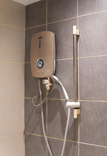 a soap dispenser on a wall in a bathroom at Cyberjaya HOMEstay With Playground Slide - 5 Pax in Gua Sai
