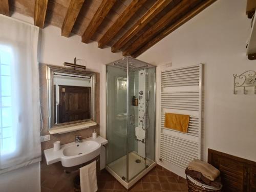 a bathroom with a glass shower and a sink at Numero6 Piazza del Popolo in Todi