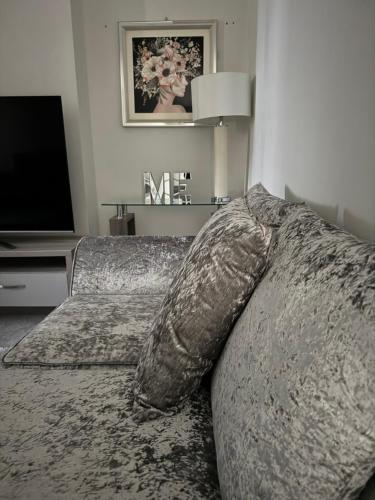 a bedroom with a bed with a pillow and a television at LUXERY 1 Bedroom Apartment - Falkirk in Falkirk