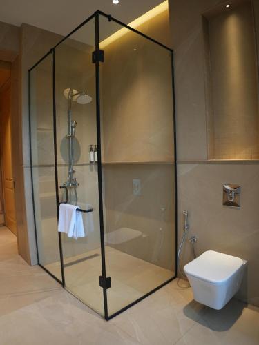 a shower stall with a toilet in a bathroom at Kazan in Amritsar