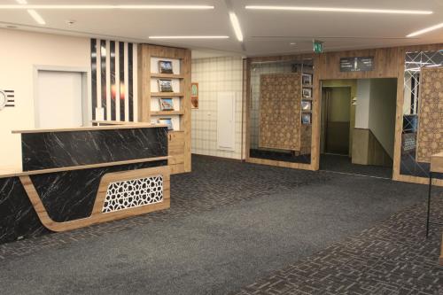 a lobby of a building with wooden walls and floors at ETÜ Konukevi 