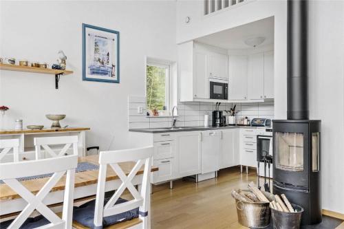 a kitchen with white cabinets and a stove at BOH128-Uddevalla-Baeve-Mallsjoen-237 in Sörvik
