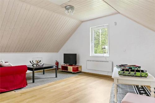 a living room with a red couch and a window at BOH128-Uddevalla-Baeve-Mallsjoen-237 in Sörvik