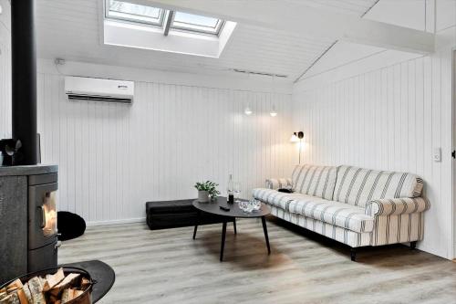 a living room with a couch and a table at TV1567-Bindslev-Svingelvej-9 in Tversted