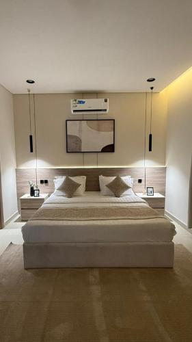 a bedroom with a large bed in a room at شفق in Al Shafa