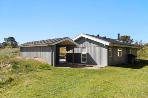 a house on top of a grassy hill at TV1567-Bindslev-Svingelvej-9 in Tversted