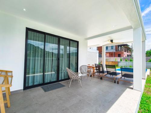 a patio with a table and chairs on a balcony at Villa Samuthra Lipa Noi in Koh Samui