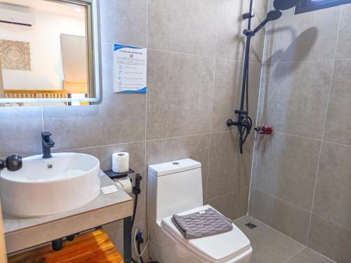 a bathroom with a sink and a toilet at Villa Samuthra Lipa Noi in Koh Samui