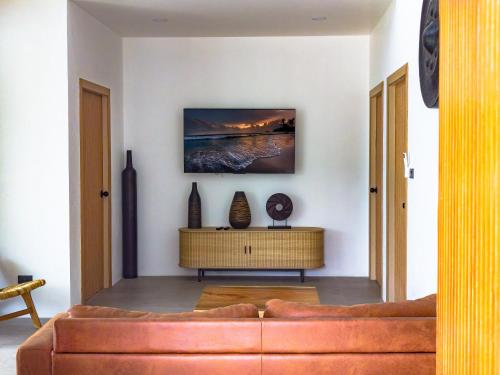 a living room with a couch and a table at Villa Samuthra Lipa Noi in Koh Samui