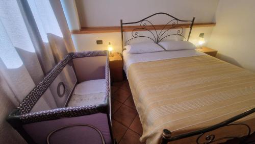a bedroom with a bed with a wrought iron frame at Terre Villa Katia in Santa Maria di Licodia