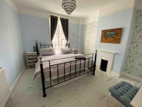 a bedroom with a bed and a fireplace at Fandango large 3 bedroom character home, Ventnor in Isle of Wight