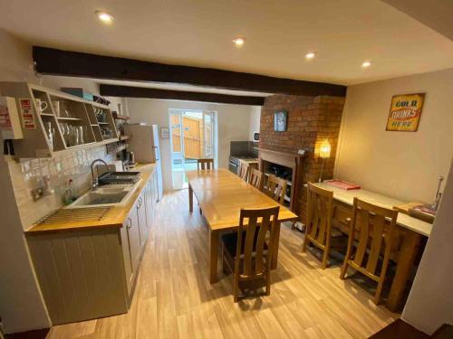 a kitchen with a table and a counter top at Fandango large 3 bedroom character home, Ventnor in Isle of Wight