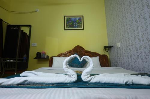 a bed with a heart made out of towels at ANAND LOK VATIKA in Rājgīr